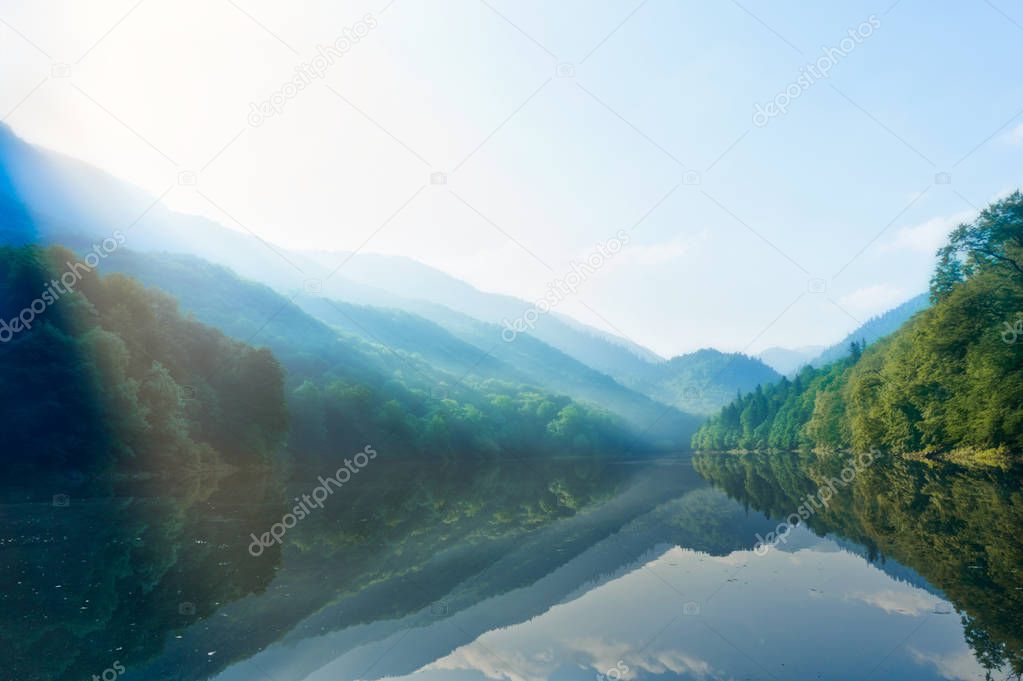 dawn on Beograd lake surrounded with green trees on hills in a morning in Montenegro
