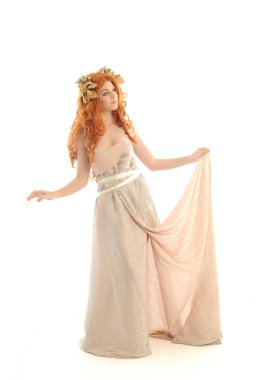 full length portrait of pretty red haired lady wearing fantasy toga gown, standing pose on white background. clipart