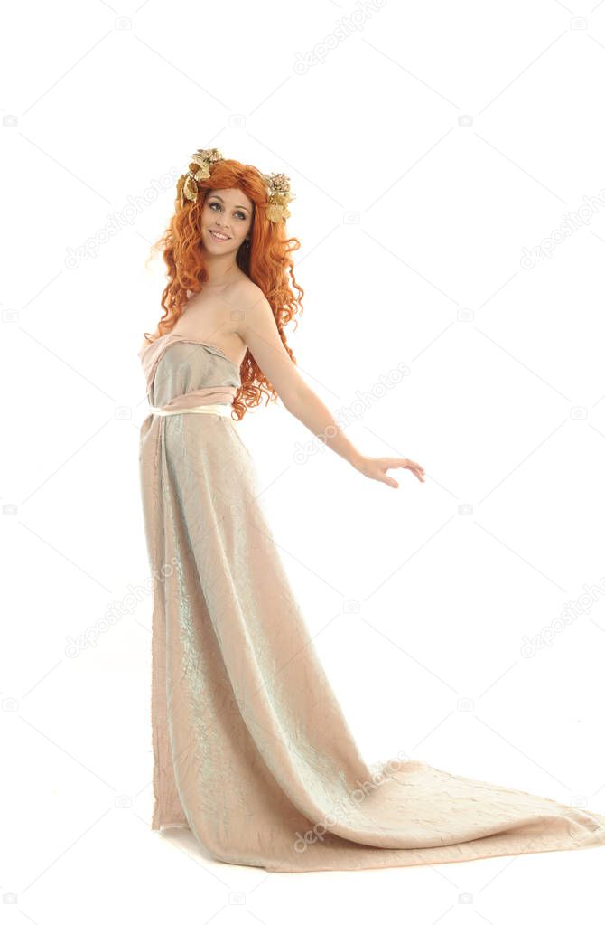 full length portrait of pretty red haired lady wearing fantasy toga gown, standing pose on white background.
