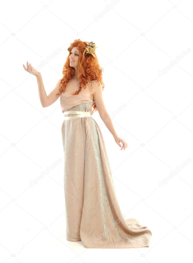 full length portrait of pretty red haired lady wearing fantasy toga gown, standing pose on white background.