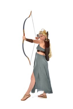 tam uzunlukta fantezi toga elbisesi giymiş ve ok ve yay tutan güzel sarışın Bayan portresi. Beyaz arka plan üzerinde ayakta poz.