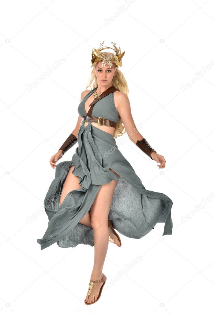 full length portrait of pretty blonde lady wearing fantasy toga gown,  and holding a bow and arrow. standing pose on white background.