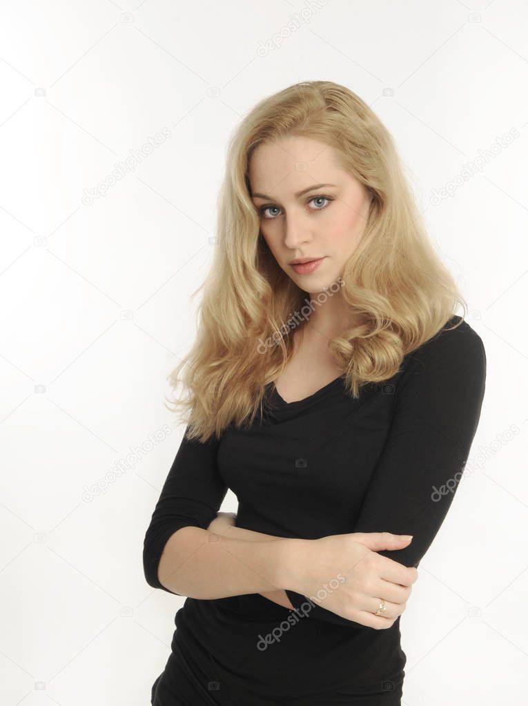 portrait of a blonde girl wearing a black shirt, on white studio background.