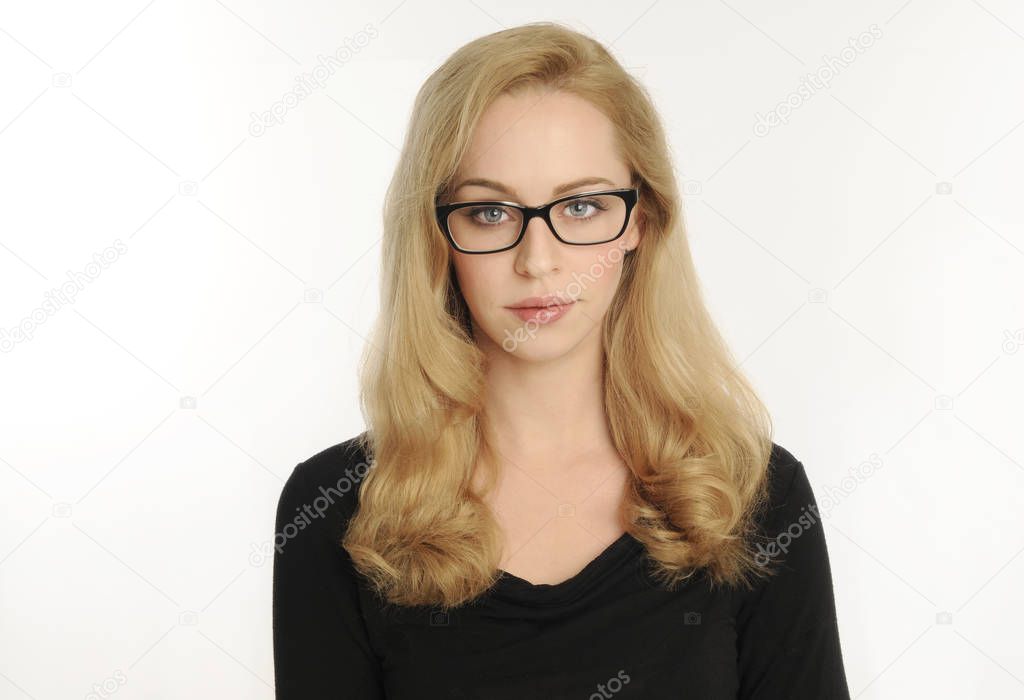 portrait of a blonde girl wearing a black shirt and glasses, on white studio background.