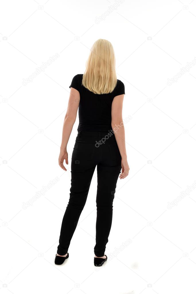 full length portrait of girl wearing black clothing. standing pose on white studio background