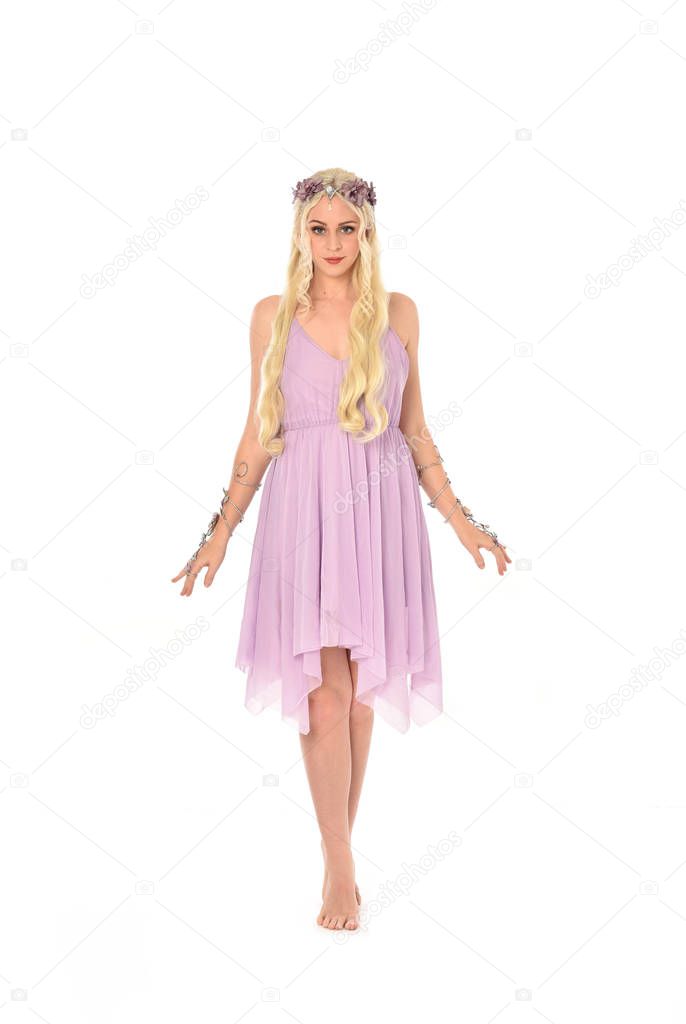 full length portrait of blonde girl wearing purple fairy costume. standing pose, isolated on white studio background.