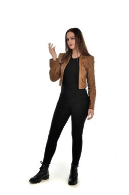 full length portrait of brunette girl wearing brown leather jacket.   standing pose on white background. clipart