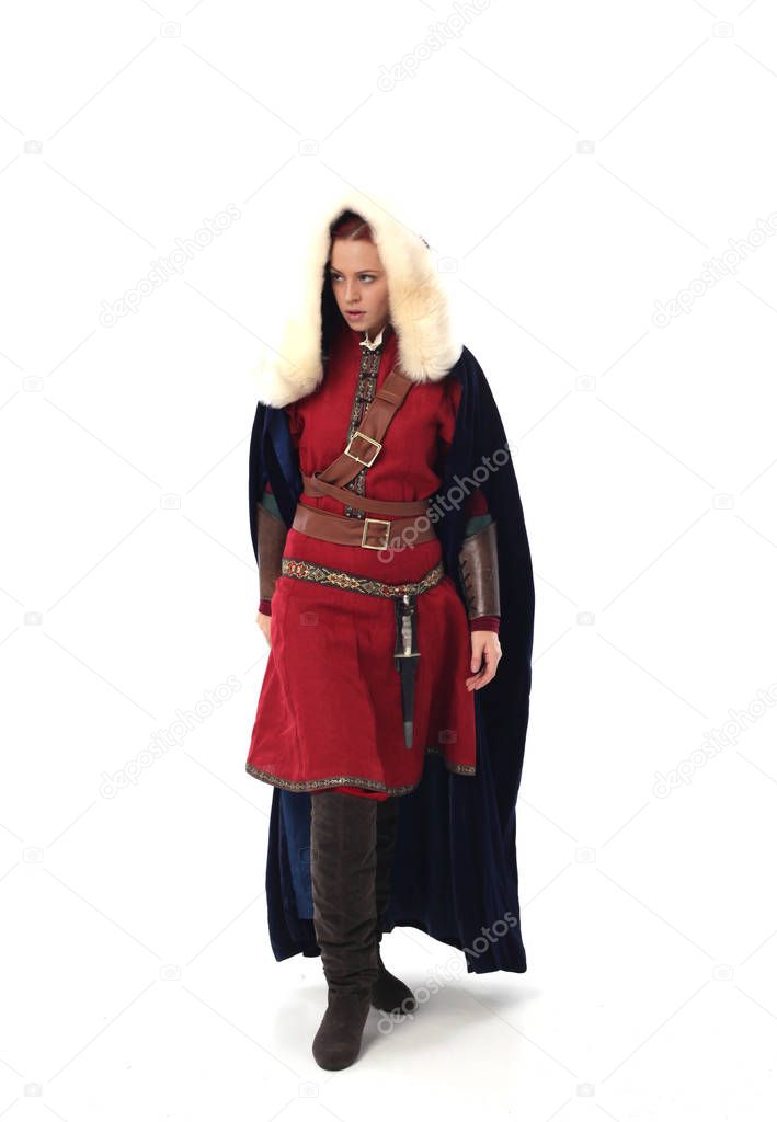 full length portrait of red haired girl wearing fantasy medieval costume, standing pose on studio background.