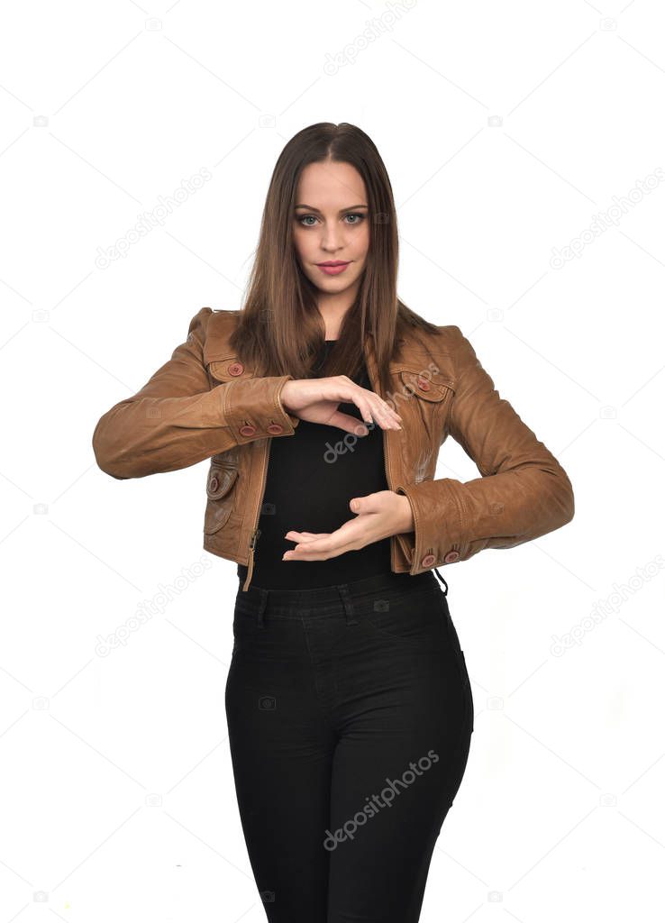 portrait of brunette girl wearing brown leather jacket.  isolated on white studio background.