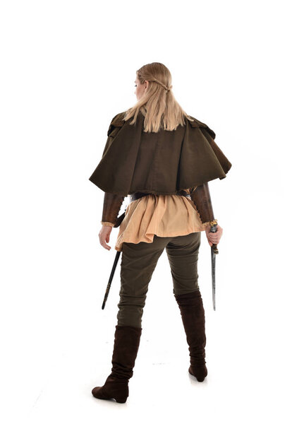 full length portrait of girl wearing medieval costume, standing pose with back to the camera. isolated on white studio background.