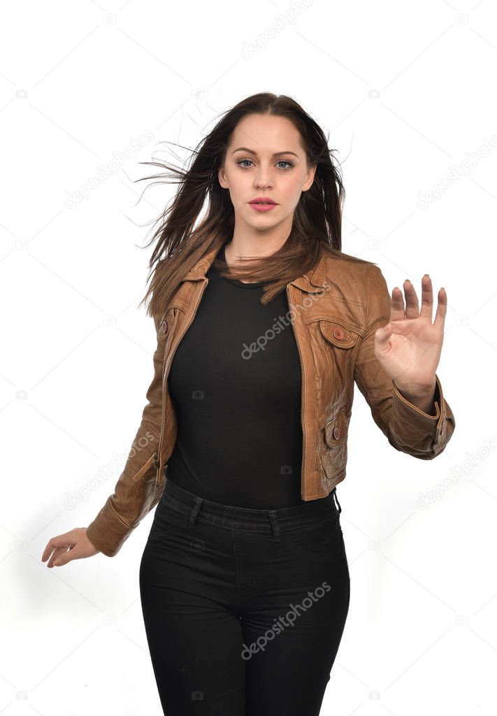 portrait of brunette girl wearing brown leather jacket.  isolated on white studio background.