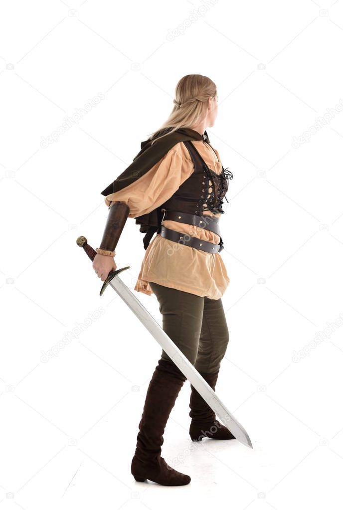 full length portrait of girl wearing medieval costume, standing pose with back to the camera. isolated on white studio background.