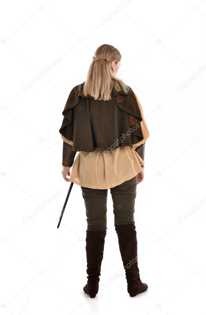 full length portrait of girl wearing medieval costume, standing pose with back to the camera. isolated on white studio background.
