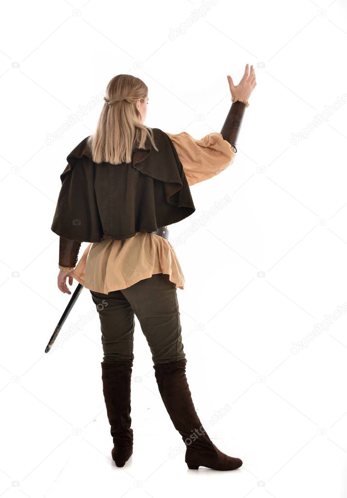 full length portrait of girl wearing medieval costume, standing pose with back to the camera. isolated on white studio background.