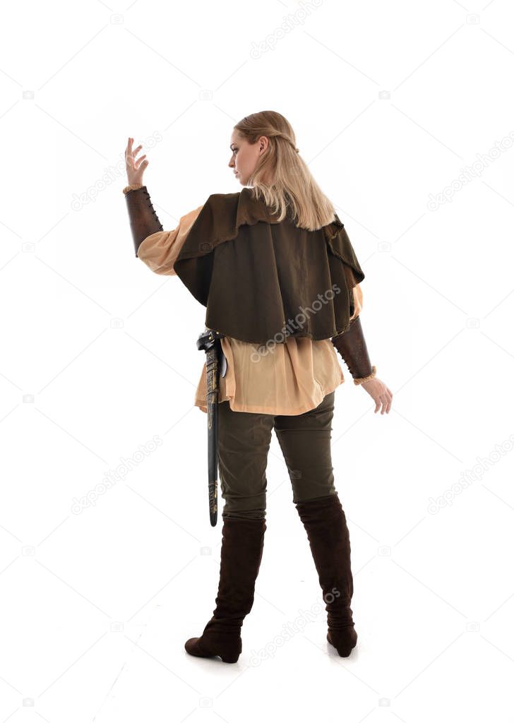 full length portrait of girl wearing medieval costume, standing pose with back to the camera. isolated on white studio background.