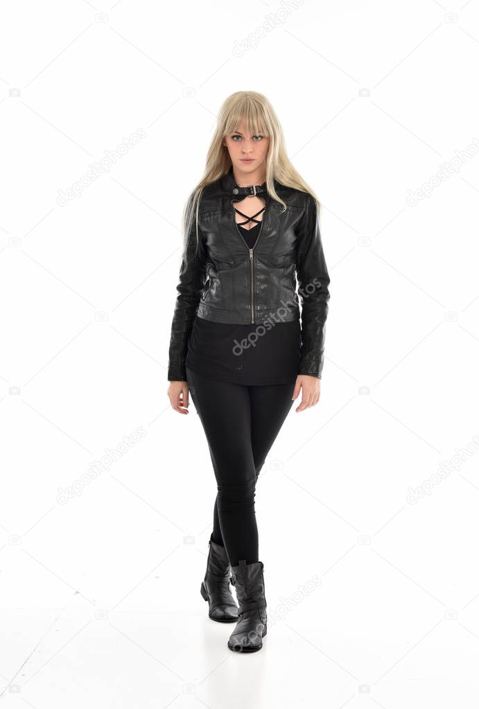 full length portrait of blonde girl wearing black leather clothes, standing pose.  isolated on white studio background.