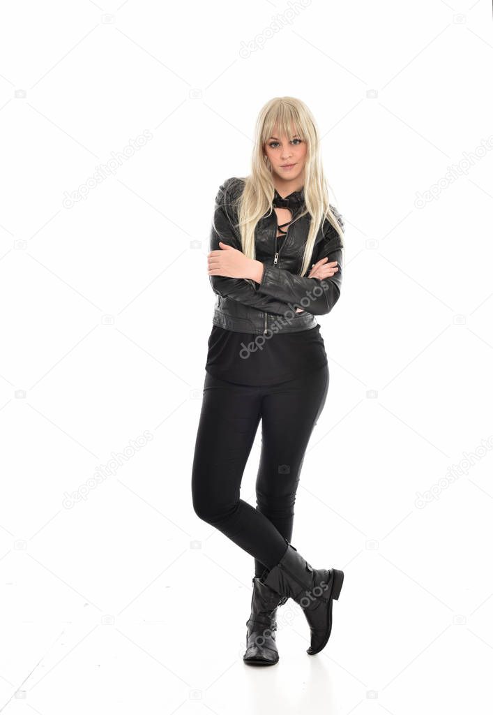 full length portrait of blonde girl wearing black leather clothes, standing pose.  isolated on white studio background.