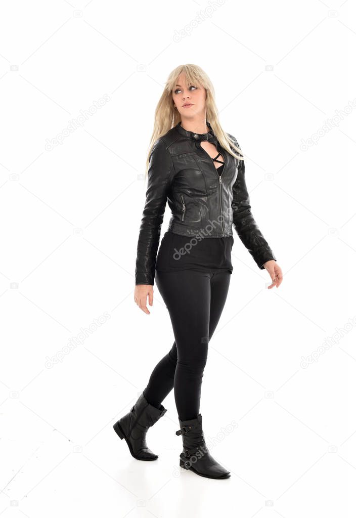 full length portrait of blonde girl wearing black leather clothes, standing pose.  isolated on white studio background.