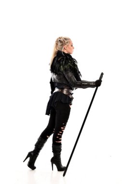 tam uzunlukta portre sarışın kız siyah yırtık kıyafeti giymiş bir personel tutarak. ayakta poz geri gönderin. beyaz stüdyo arka plan üzerinde izole.