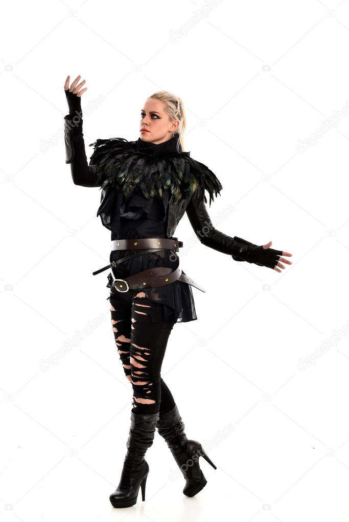 full length portrait of blonde girl wearing black, torn gothic outfit. standing pose, isolated on white studio background.