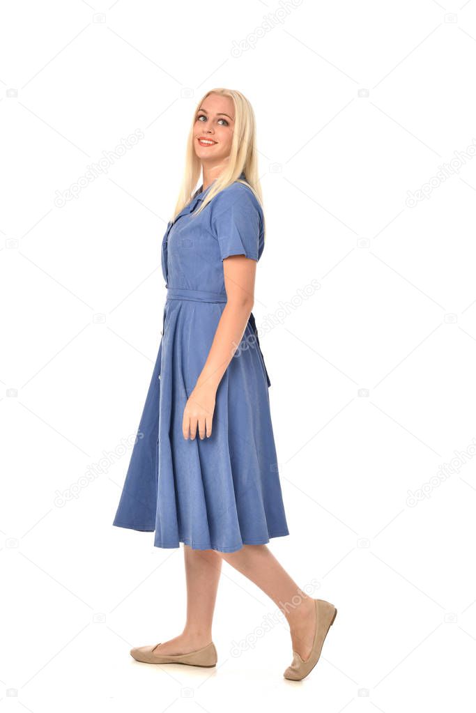 full length portrait of blonde girl wearing blue dress, standing pose. isolated on white  studio background.