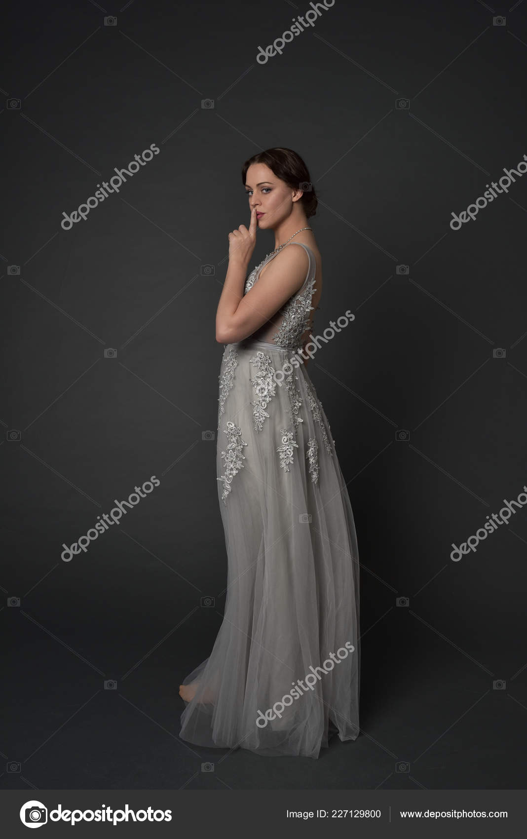 Elegant woman in blue ball gown dress standing and posing on a sunny evening  at city street. Fashion model full length portrait Stock Photo | Adobe Stock