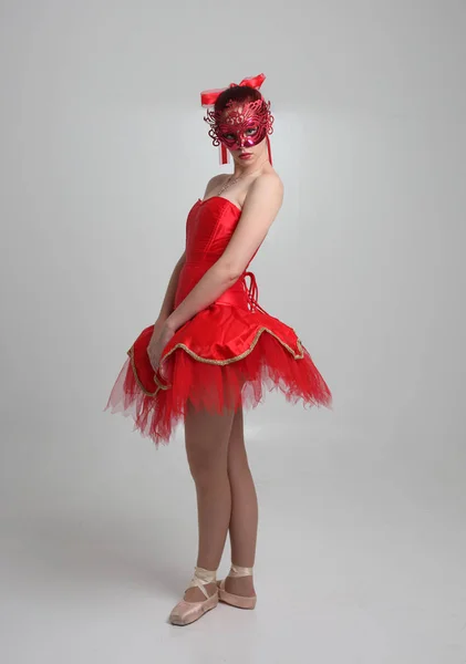穿红色芭蕾舞衣和面具的女孩的全长肖像 在工作室背景上跳舞姿势 — 图库照片