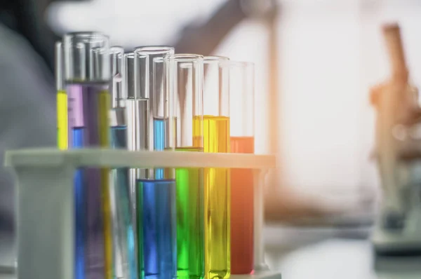 Chemical tube, put on table, With colorful fluids, In glass tubes for cosmetics from notebooks, in the laboratory, the concept develops safe formulas for consumers.