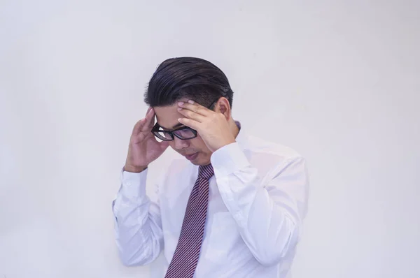 Young businessman, with hands on head, with pressure on work, on white background, Concepts of health and work stress.