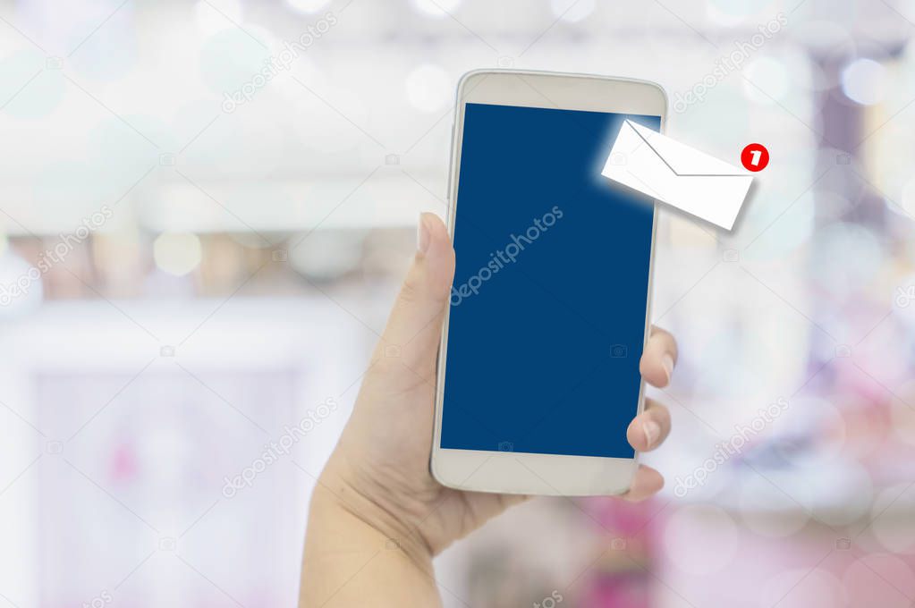 Close-up hands of businesswomen holding smartphones with alert icons unread messages, communication concepts and technology with the convenience of wireless networks.