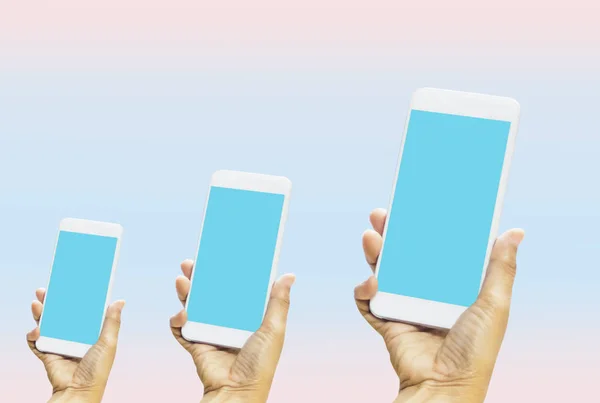Women holding smartphone in hands with blue screen on bright blue-pink pastel background. With concept of technology and simplicity and convenience,with empty copy space and for text and image — 스톡 사진