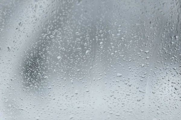 Background in the form of misted glass with water drops
