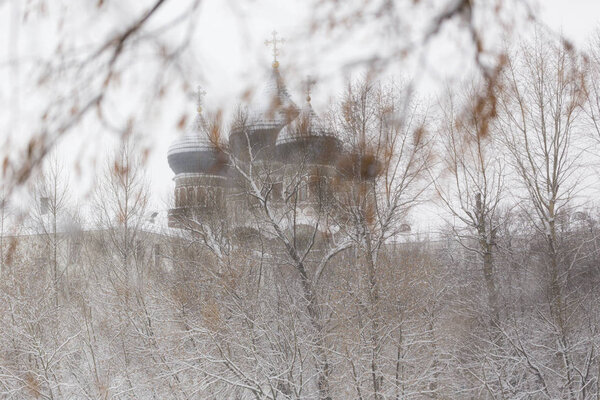 Православная церковь в заснеженном парке в холодный зимний день. Измайловский остров в Москве, Россия
