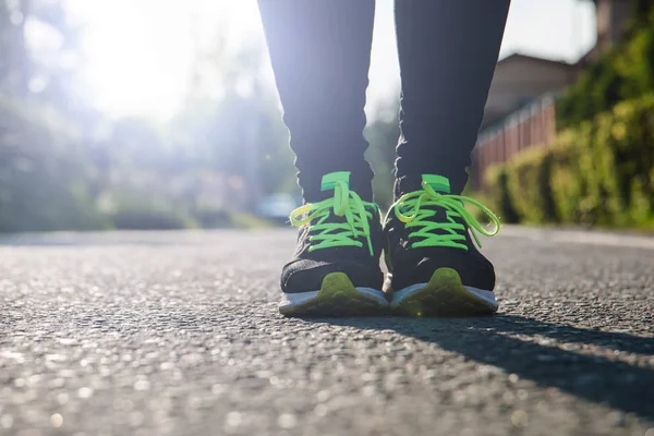 Runner feet running on road,woman fitness sunrise jog workout welness concept.