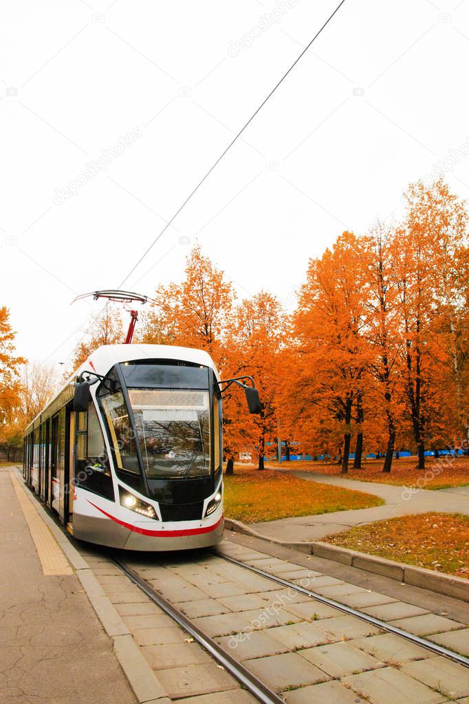 public transport, modern city tram, approaching the bus stop.