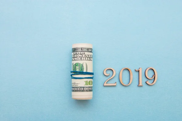 dollar money into the pipe and wooden figures 2019, the new year will be richer.