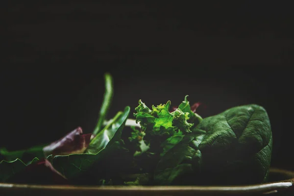 Green vegan Breakfast in a bowl with various leaves, top view. Clean eating, dieting, vegan schematic diagram of the food.