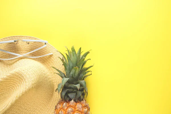 stock image Fresh ripe pineapple glasses hat on color background, top view