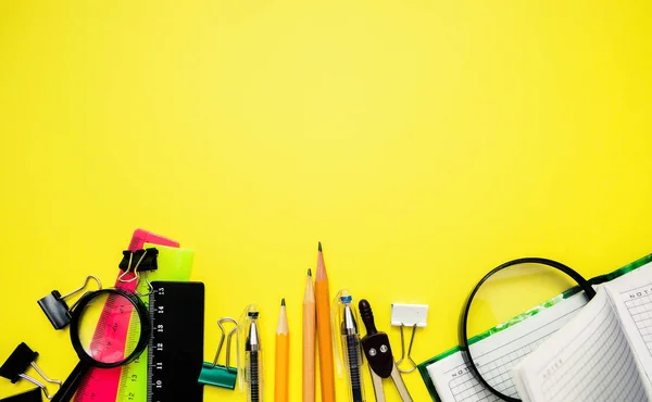 Education or back to school Concept. Top view of Colorful school supplies with books, color pencils, calculator, pen cutter clips and green apple on chalkboard background. Flat lay — Stock Photo, Image