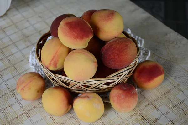 Fresh fragrant and sweet peaches in the basket