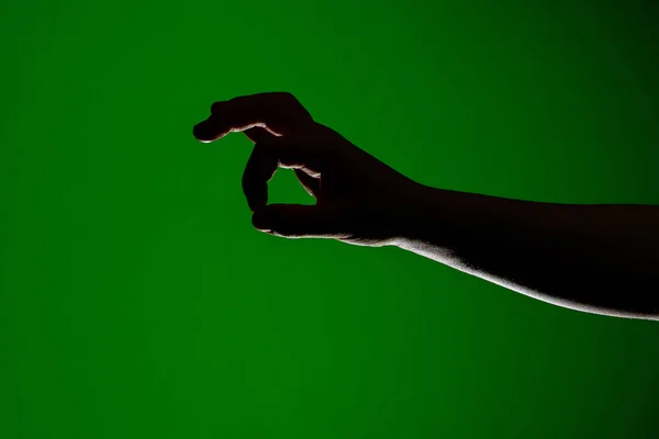 Human hand, folded together to take a little small, isolated on a red background