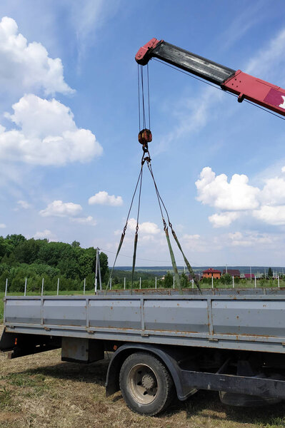 The car crane transports the metal profile from the car body.