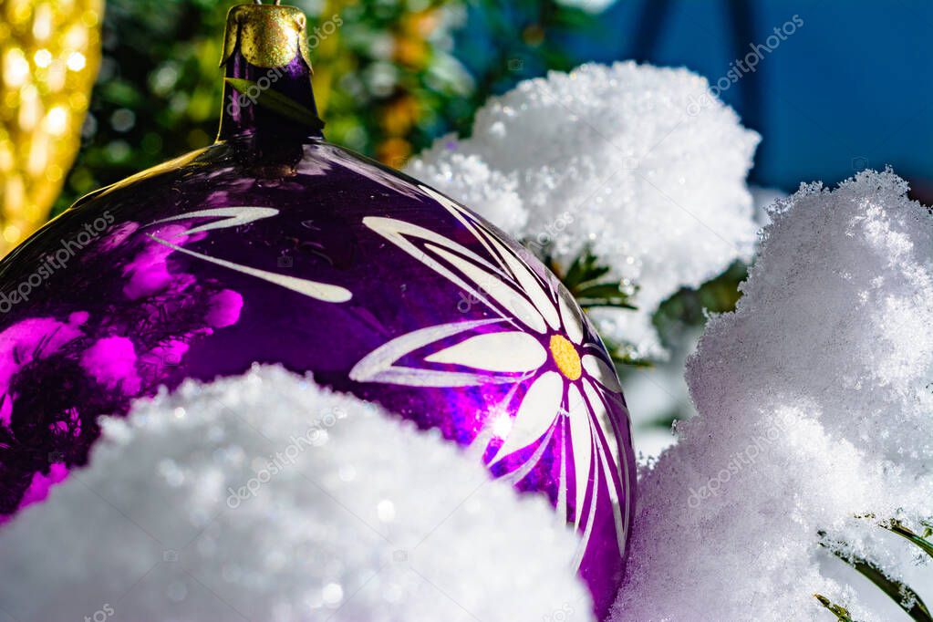 A real Christmas tree in the Ukrainian village of western Ukraine smothered by snow on the street and decorated with colorful balls
