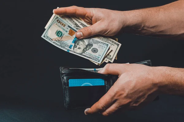 Άντρας Μαύρο Φόντο Κρατά Στα Χέρια Του Ένα Πορτοφόλι Δολάρια — Φωτογραφία Αρχείου