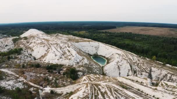 Aerial 4k video of a green artificial lake in the white mountains. Phosphate-gypsum heaps from industrial waste in Ukraine. — Stock Video