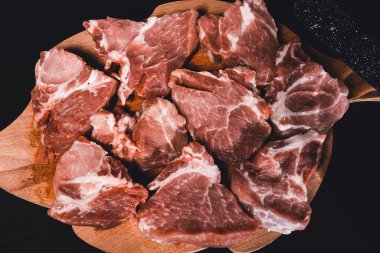 Siyah arka planda dilimlenmiş et. Baharatlı marine edilmiş domuz eti 2021 'de kebap pişirmeden önce kapanıyor..