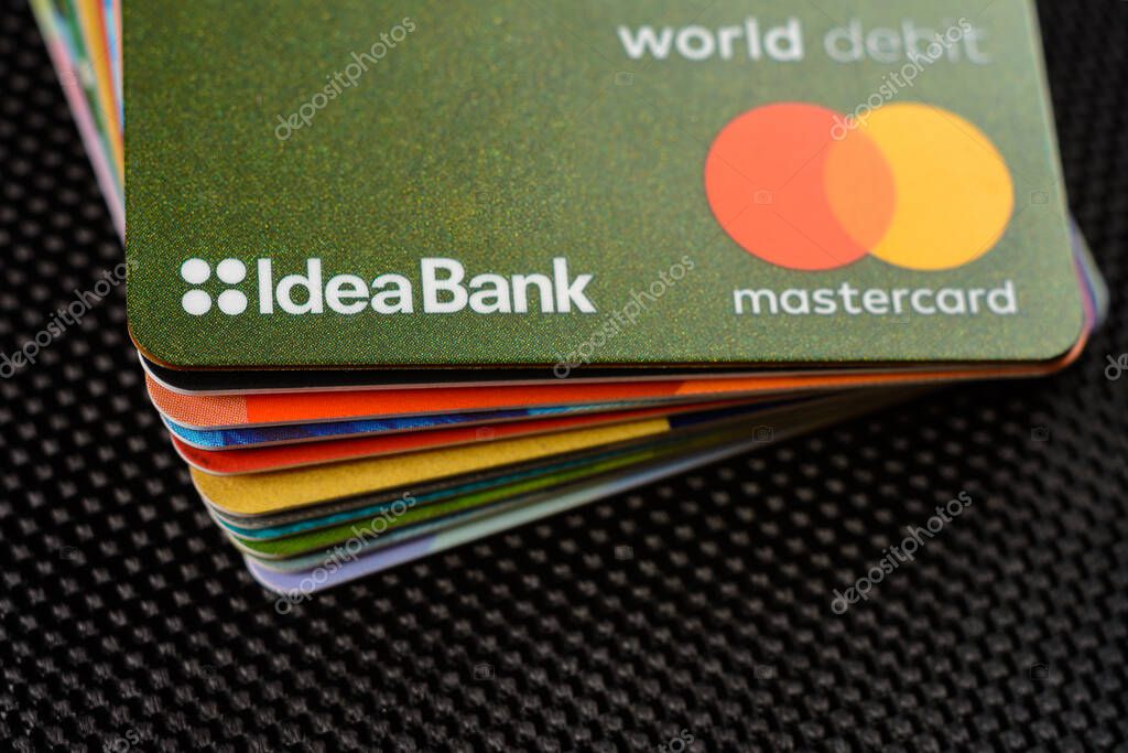 Lviv, Ukraine - 26 April 2019 : Stack of colorful credit cards of the Ukrainian bank titled IdeaBank 2020