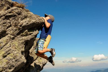 Çocuk dağcılıkla meşgul, bir çocuk kayalık bir dağa tırmanıyor, cesur bir çocuk. 2020