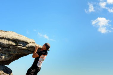 Turist tırmanışçısı, Ukrayna Karpatları, tehlike ve aşırılık olmadan büyük kayalık bir kayaya tırmandı. 2020