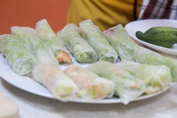 Chef giving cooking classes in kitchen Fried spring rolls tasty healthy dishes with vegetables Vietnamese cuisine